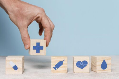 Healthcare symbols on wooden blocks.